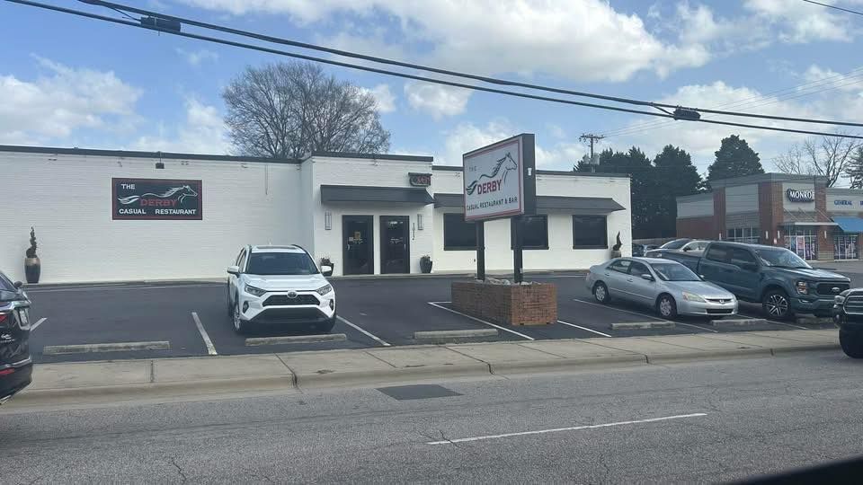 A white building with cars parked in front of it