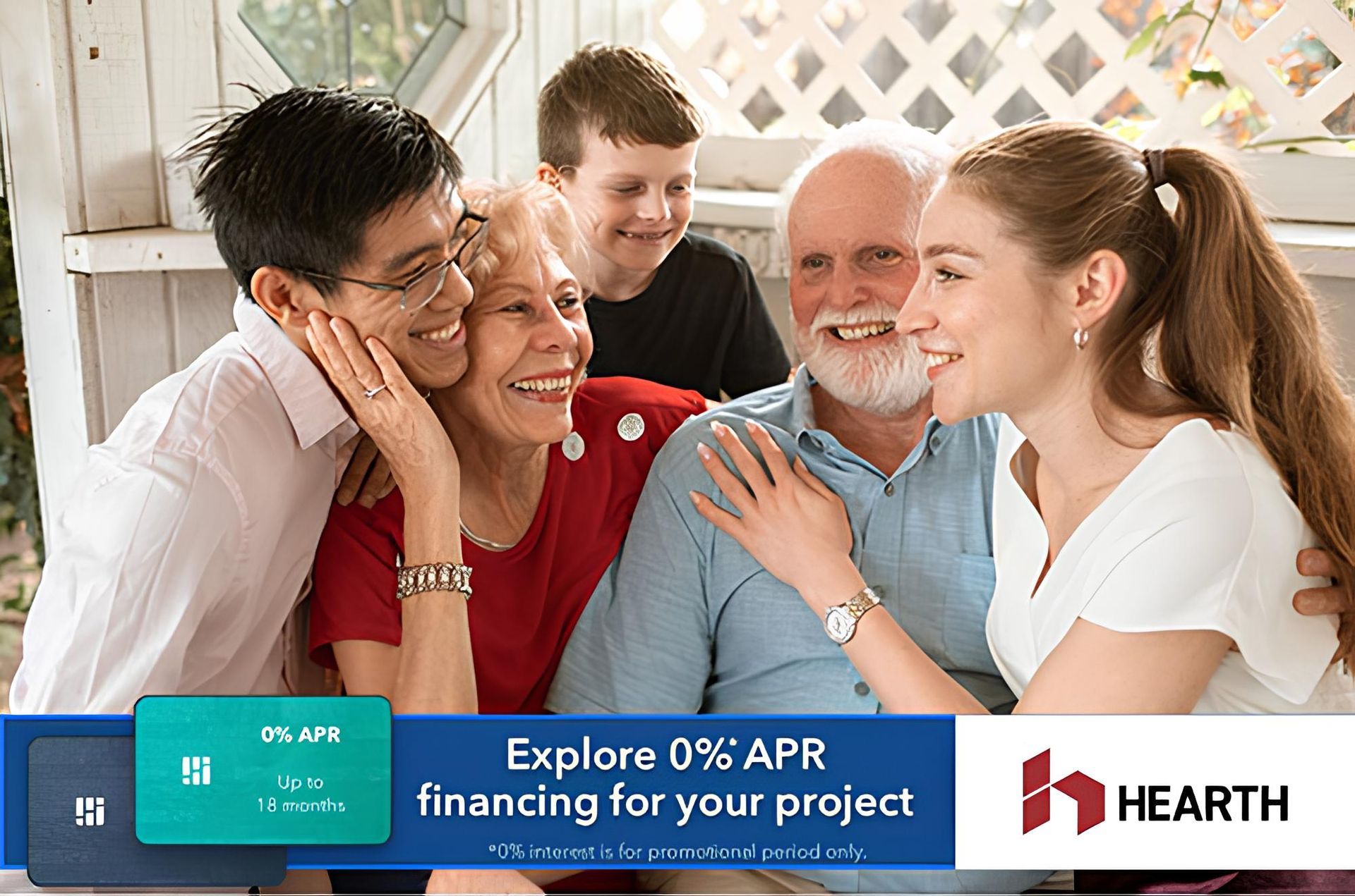 A family is posing for a picture together on a porch