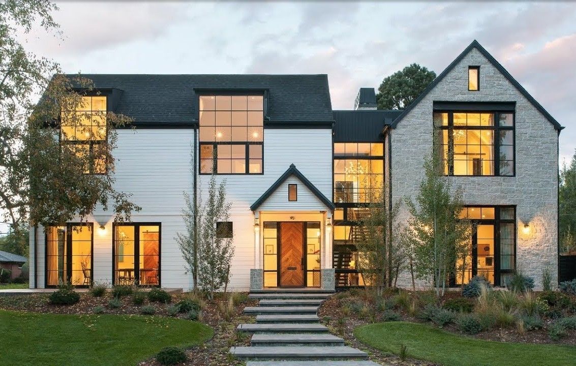 A large white house with a black roof and many windows