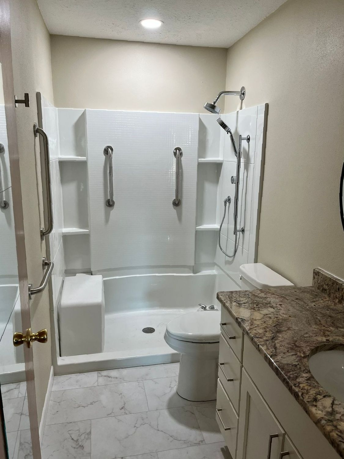 A bathroom with a toilet , sink , shower and bathtub.