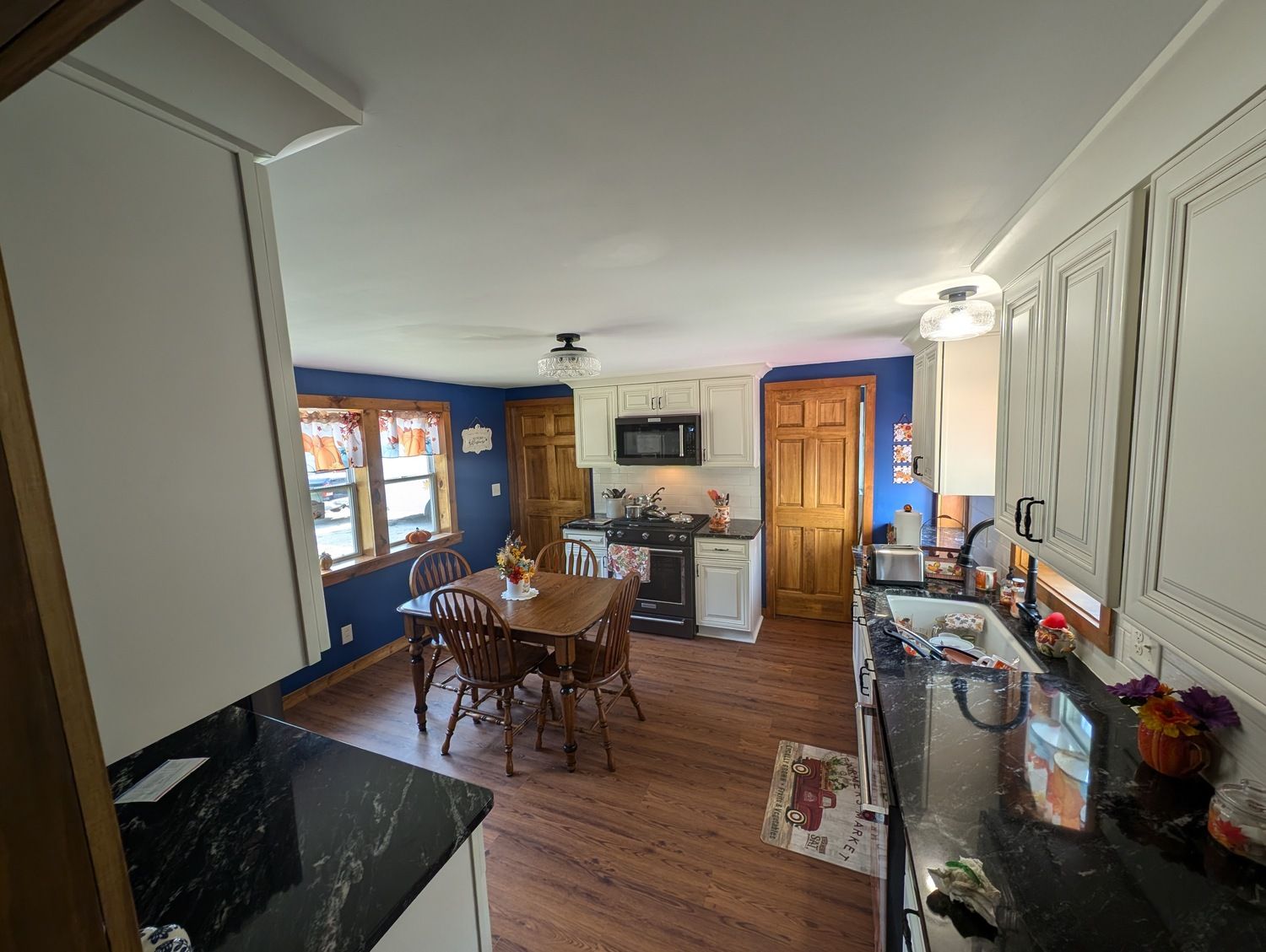 A kitchen with a table and chairs in it