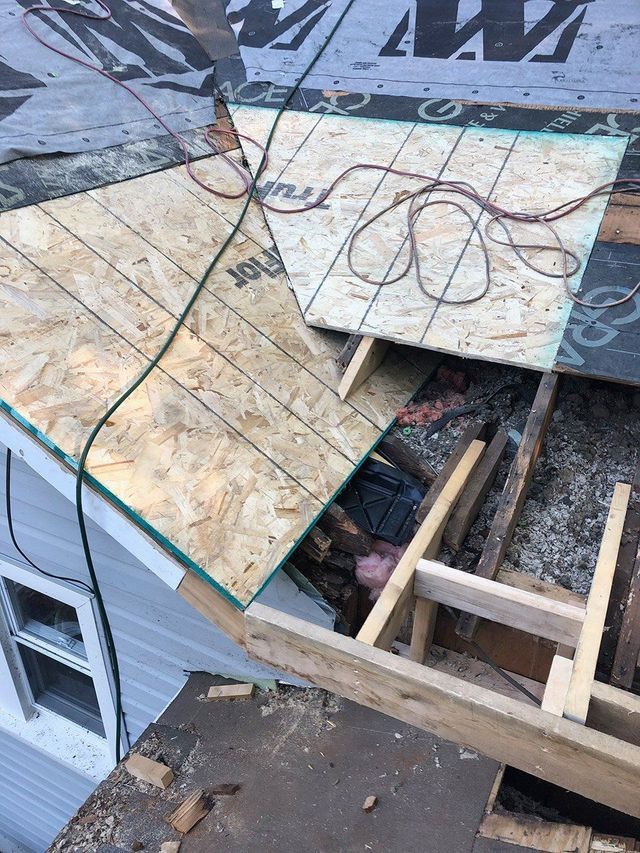 Roof under repair: OSB board, exposed framing, electrical wires, and damaged shingles.