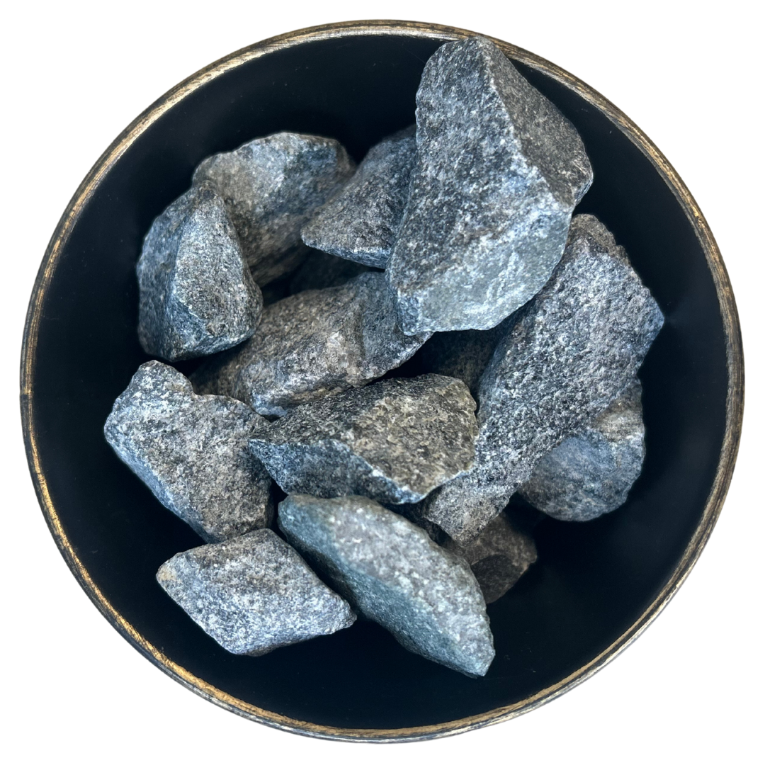 A black bowl filled with rocks on a white background.