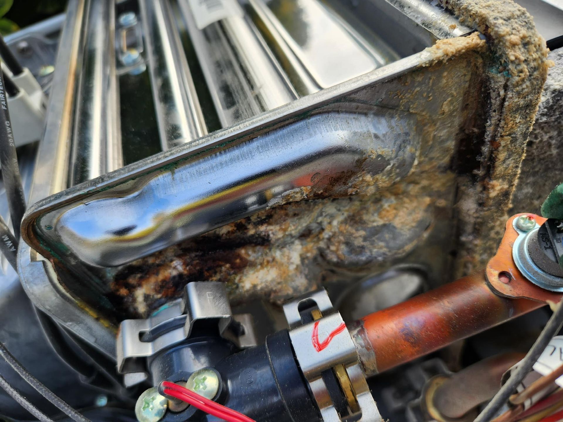 A close up of a rusty pipe on a machine.