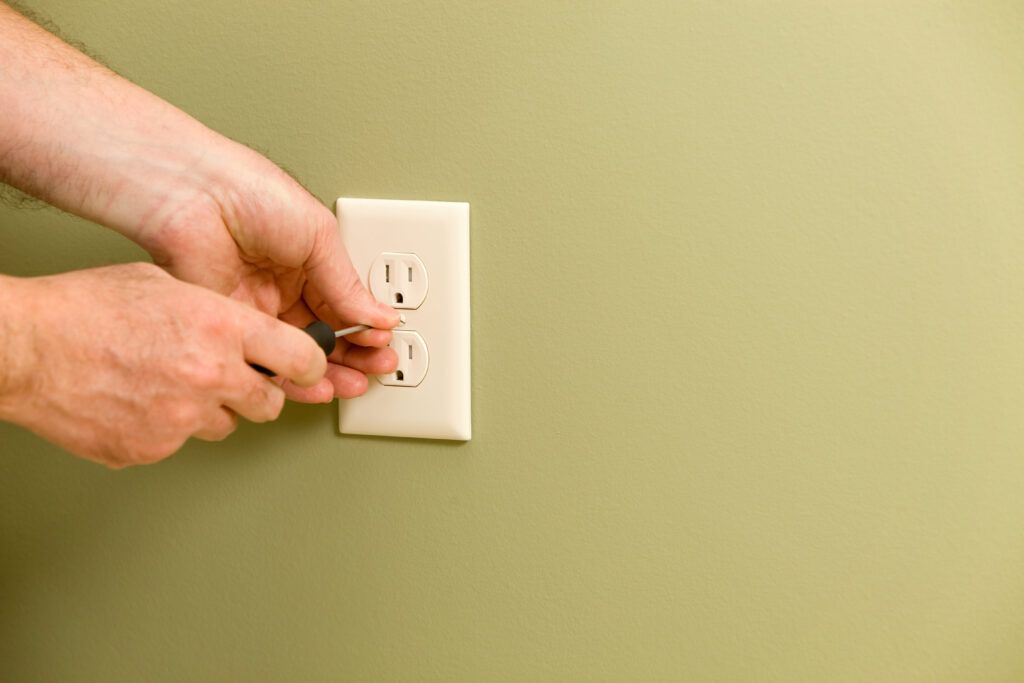 Electrician Installing Electric Outlet Cover