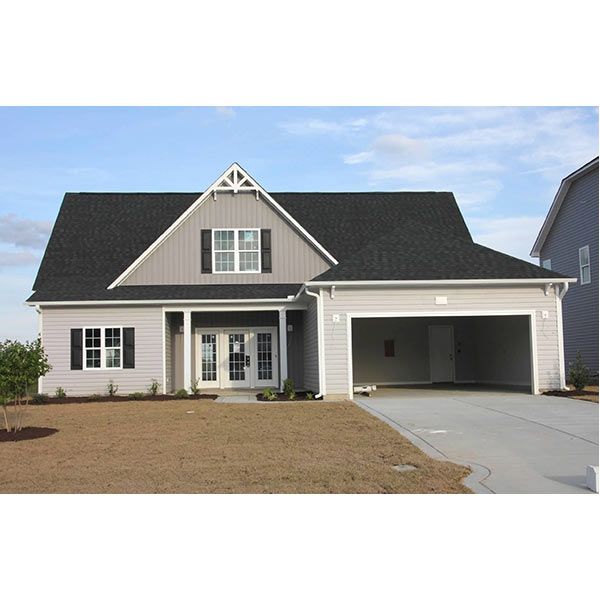 A house with a black roof and a garage