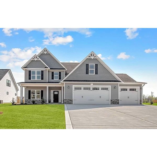 A large gray and white house with two garage doors and a large driveway.