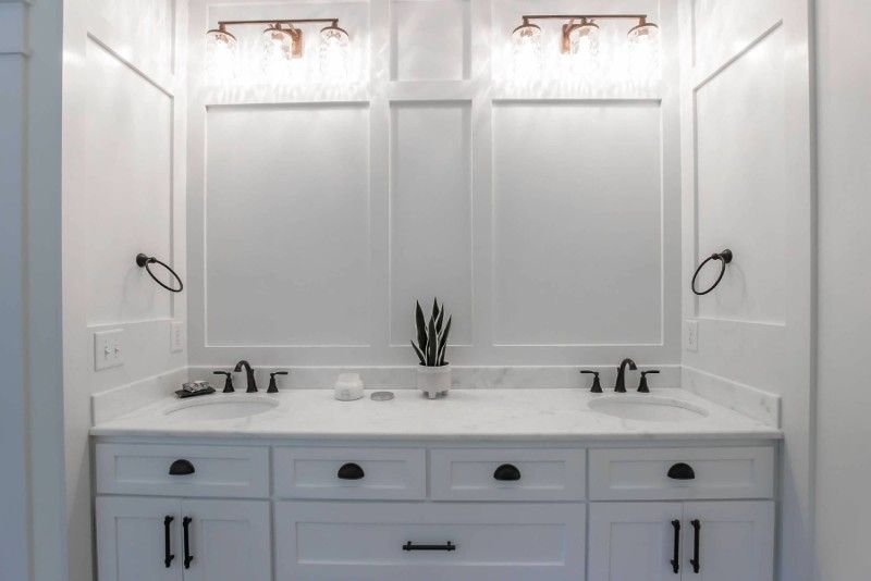 A bathroom with two sinks and two mirrors.