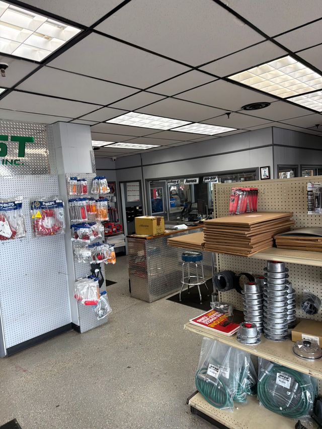 Retail store interior with shelves, stacked trays, and fluorescent ceiling lights