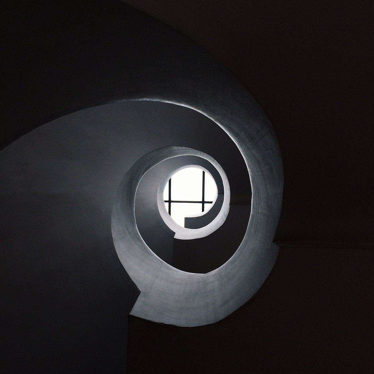 A black and white staircase appears as an ominous tunnel.