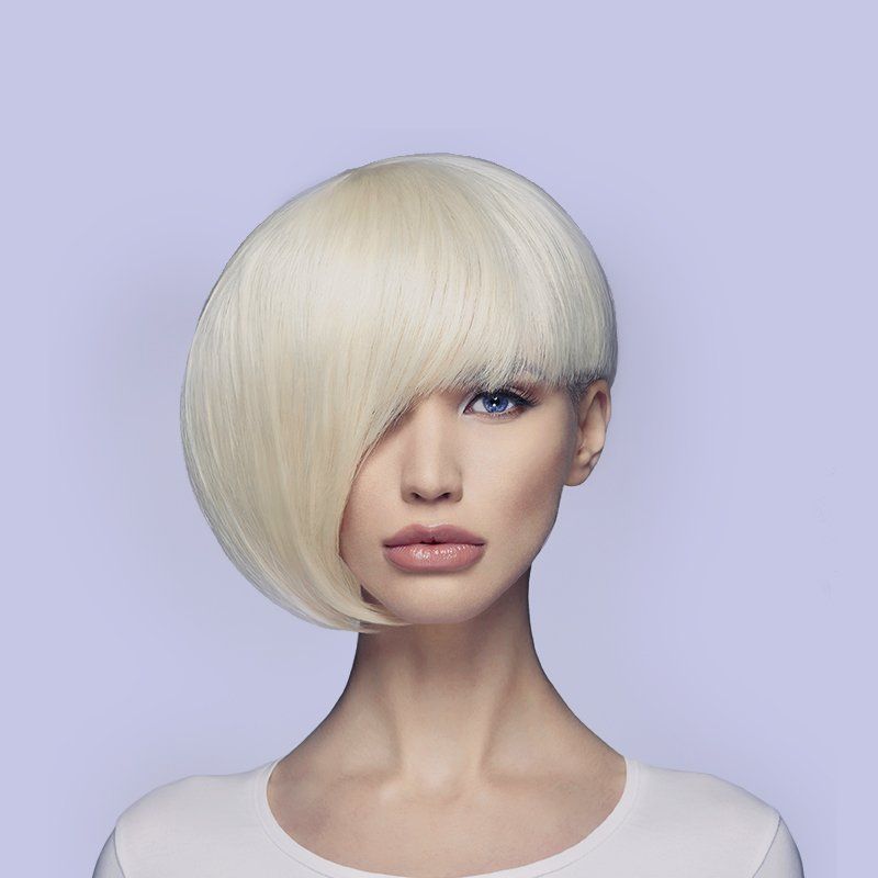 Portrait of a person with platinum blonde asymmetrical bob against a lavender background